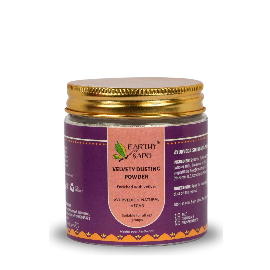 Earthy Sapo Velvety Dusting Powder in a glass jar with a gold lid.