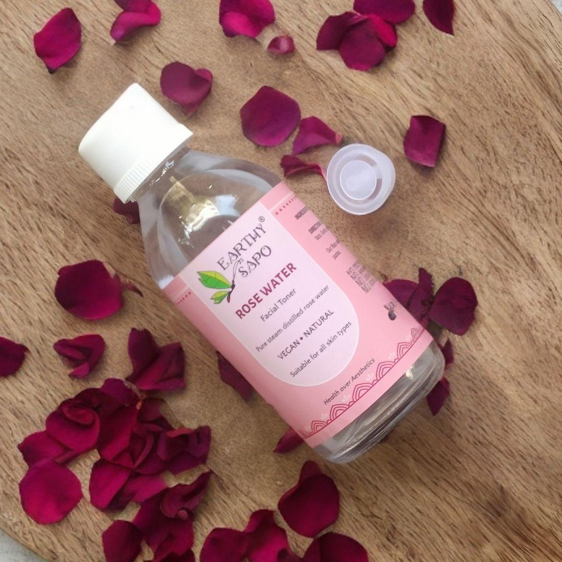 Earthy Sapo Pure Rose Water Facial Toner with fresh rose petals for natural skincare.