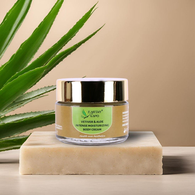 Earthy Sapo Vetiver & Aloe Intense Moisturizing Body Cream displayed with an aloe vera leaf.